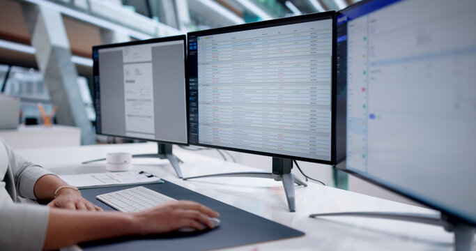 Woman Using Office Invoice Software For Payroll Processing In Medical Office