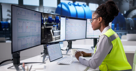 Young Female Engineer Optimizing Industrial Systems © Andrey Popov