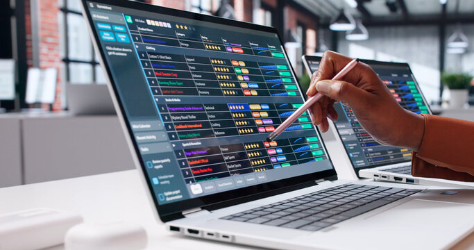 Young African American Woman Calculating Revenue With Laptop
