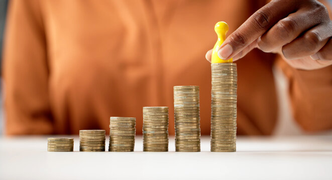 Corporate Woman Holding Stack Of Coins