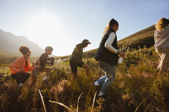 Group hiking through a sunny field