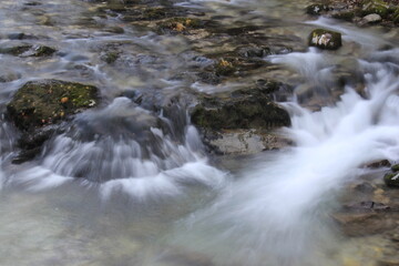 River with vivid rocks, stones, waterfalls and fog like water in the air.