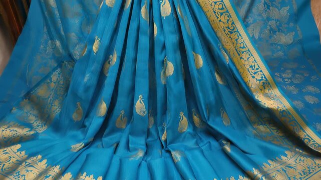 Intricate Gold Floral Pattern on Blue Silk Fabric - Luxury Textile Detail, High-Resolution Texture Background.