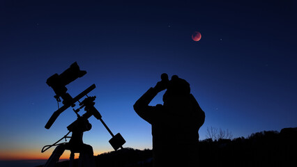 Amateur astronomer observing stars, planets, Moon eclipse and other celestial objects. © astrosystem