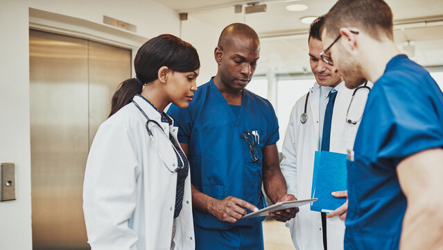 Black surgeon giving instruction to his multiracial medical team