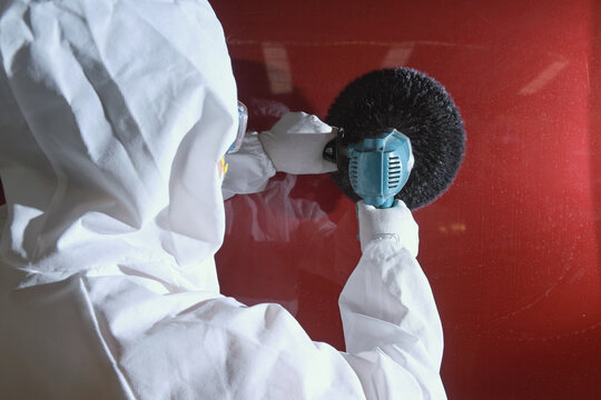 Painting the car in black color in the paint chamber on the serv