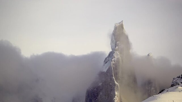 Timelapse of Cerro Torre rising above moving clouds in Patagonia. Dramatic mountain scenery showcasing one of the most iconic peaks in the Patagonian Andes.