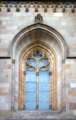 Arched gothic glass window on the stone wall