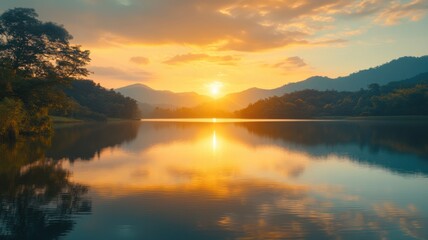 Obraz premium Golden Hour Reflection on Tranquil Mountain Lake at Sunset sunset lake reflection tranquil water sky