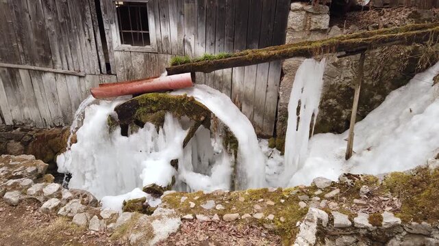  Frozen water mill with frozen water ice at winter in a village