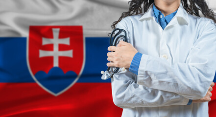 Fototapeta premium Healthcare professional with Slovakia flag background. Professional doctor holding stethoscope on Slovakia flag background