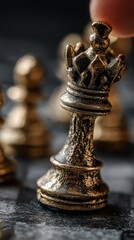 Fototapeta premium Hand manipulating gold chess king piece in strategic choice. Choosing by hand a golden king chess piece on a dark background, signifying command and strategy