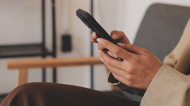 Young casual Businessman holding and using smartphone for sms messages, hipster man typing touchscreen cell phone in the cafe. business, lifestyle, technology and Social media network concept