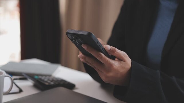 Young casual Businessman holding and using smartphone for sms messages, hipster man typing touchscreen cell phone in the cafe. business, lifestyle, technology and Social media network concept