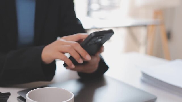 Young casual Businessman holding and using smartphone for sms messages, hipster man typing touchscreen cell phone in the cafe. business, lifestyle, technology and Social media network concept