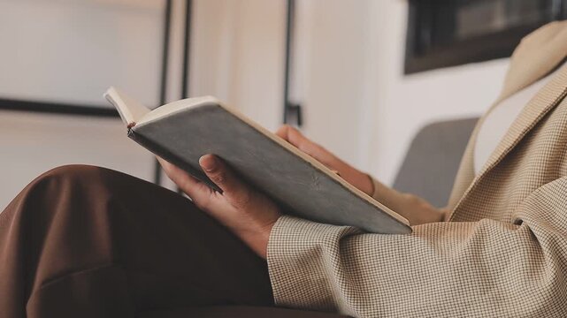 Elearning. Close up of smiling young female remote student watch training lecture on laptop pc take notes at paper workbook by hand. Millennial lady get distant education write thesis of online lesson