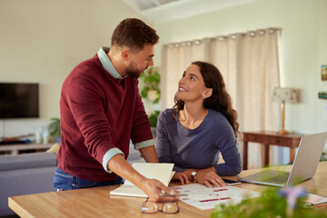 Mid adult couple discussing finance at home