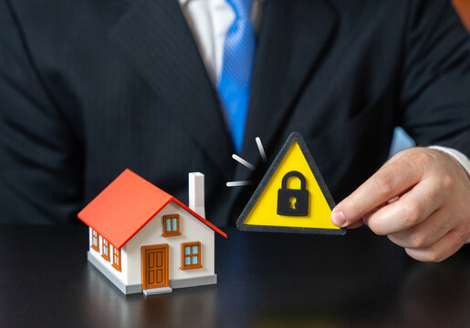 House under lock and key. Property protection. Guarantees and insurance. Asset freezing, house seizure. Real estate risk concept, legal restrictions and safeguarding property from financial threats
