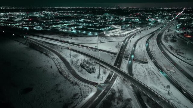 Night aerial view of snowy Mississauga highways 403 and QEW