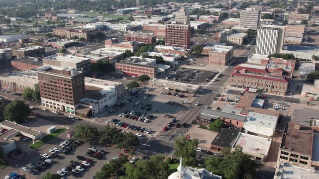 4K right pan drone footage of downtown Waco, Texas, showcasing city buildings, streets, and skyline architecture with smooth cinematic aerial motion on a clear day.