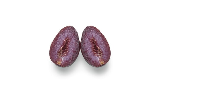 Two Seedless grapes and a halved grape on a white background