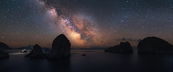 Fototapeta premium Night sky with Milky Way and rocks in SAM PHAN BOK PARK, Ubon Ratchathani Province, Thailand - High ISO image with noise