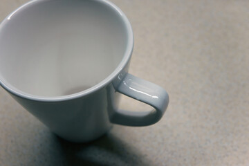 White coffee cup on table close up