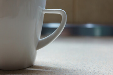 White coffee cup on table close up