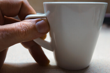 White coffee cup on table close up