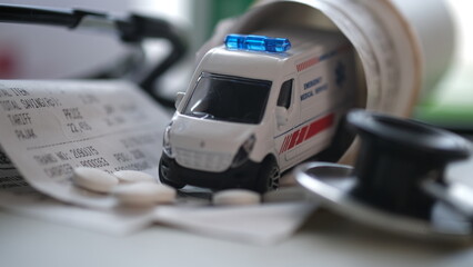 Hospital ambulance vehicle with hospital bills and medicines. © wisely