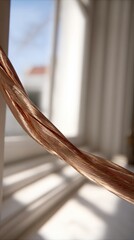 Close up of flowing hair in soft natural light by a window