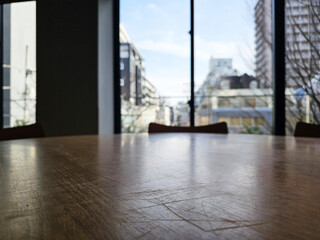 Close up Surface of Wooden Table in Cafe with View of Tokyo City Buildings in the winter Background.