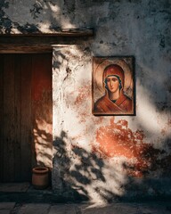 Woman standing gracefully against a weathered wall with sacred icon and muted warm shadow details
