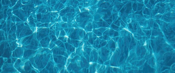 Obraz premium Dark blue pool water featuring shimmering sunlight patterns