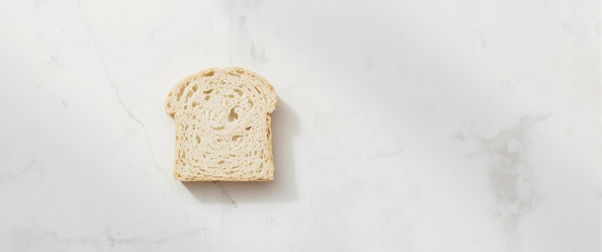 Isolated white bread slice on white stone surface