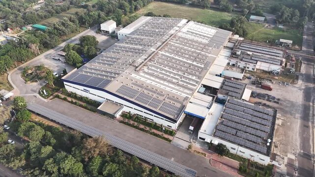 Aerial view of a modern industrial facility with expansive rooftop solar panels, showcasing large-scale manufacturing infrastructure and the growing shift toward renewable energy.