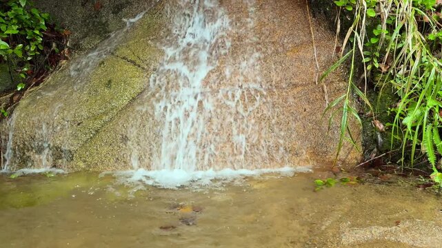 Water pouring down granite stone in troise frere mountain trail, Mahe, Seychelles 25fps.