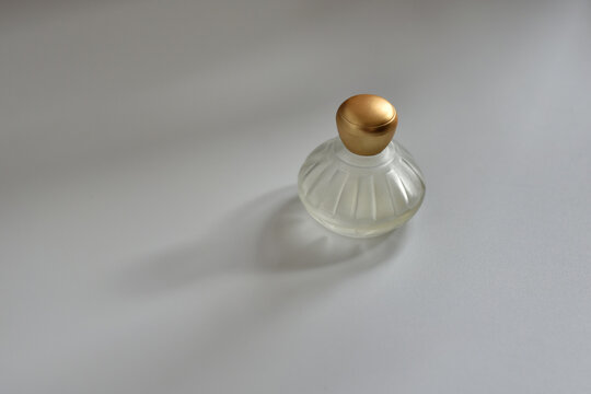 Perfume bottle on white background in the soft natural light