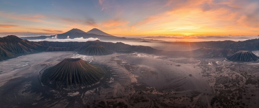 Panoramic aerial shot of Mount Bromo volcano with Mount Batok cone near the sea of sand in Java, Indonesia