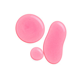 Drops of pink cosmetic oil on white background