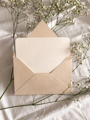 Pink envelope empty card and flowers. Valentine`s Day aesthetic