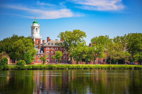 Cambridge, Massachusetts, USA - June 05, 2025 Harvard University Eliot House and tower viewed across the Charles River in Cambridge, Massachusetts