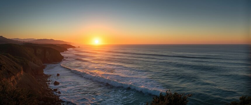Dusk over Bodega Bay in California with the sun setting and ocean waves hitting the shore