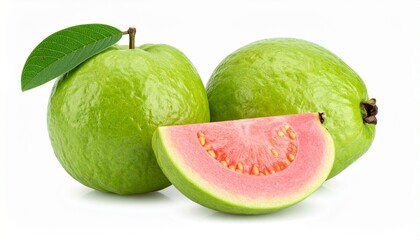Whole guava with pink slices and green leaves on natural surface