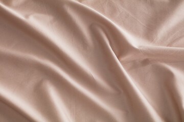 A set of soft bed sheets and pillowcases are neatly arranged on a bed. The color is light and the fabric looks smooth. This setup is common in bedrooms for comfort.