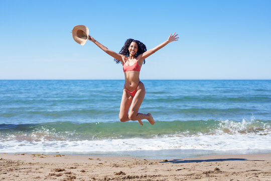 Joyful Beach Day A Young Woman Celebrating and Having Fun by the Beautiful Ocean Waves