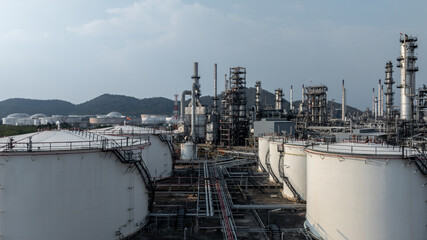 Aerial view oil and gas petrochemical tank with oil and gas refinery plant background, Global business power and energy petrochemical barrel, Petrochemical refinery industrial energy supply chain.