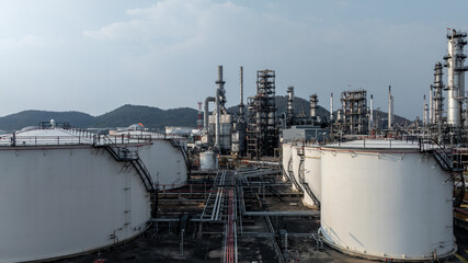 Obraz premium Aerial view oil and gas petrochemical tank with oil and gas refinery plant background, Global business power and energy petrochemical barrel, Petrochemical refinery industrial energy supply chain.