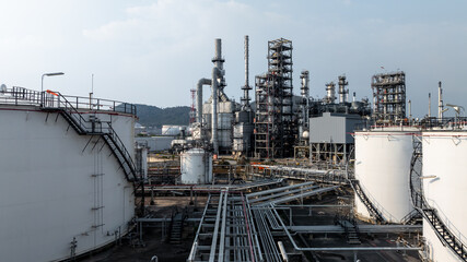 Aerial view oil and gas petrochemical tank with oil and gas refinery plant background, Global business power and energy petrochemical barrel, Petrochemical refinery industrial energy supply chain.