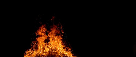 Fototapeta premium Fire burning and glowing on a dark background